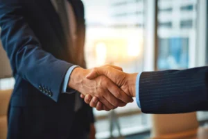 Two professionals shaking hands, representing a medical billing business partnership