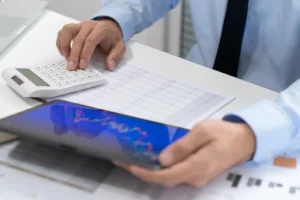 Healthcare business owner reviewing revenue figures and financial reports