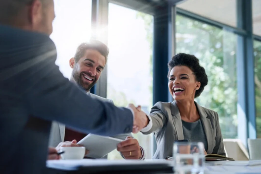 Billing company owner and healthcare provider shaking hands after signing a Business Associate Agreement