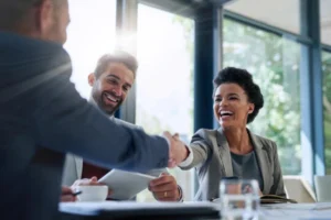 Billing company owner and healthcare provider shaking hands after signing a Business Associate Agreement