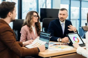 Practice managers reviewing patient balance and collections reports in a conference room